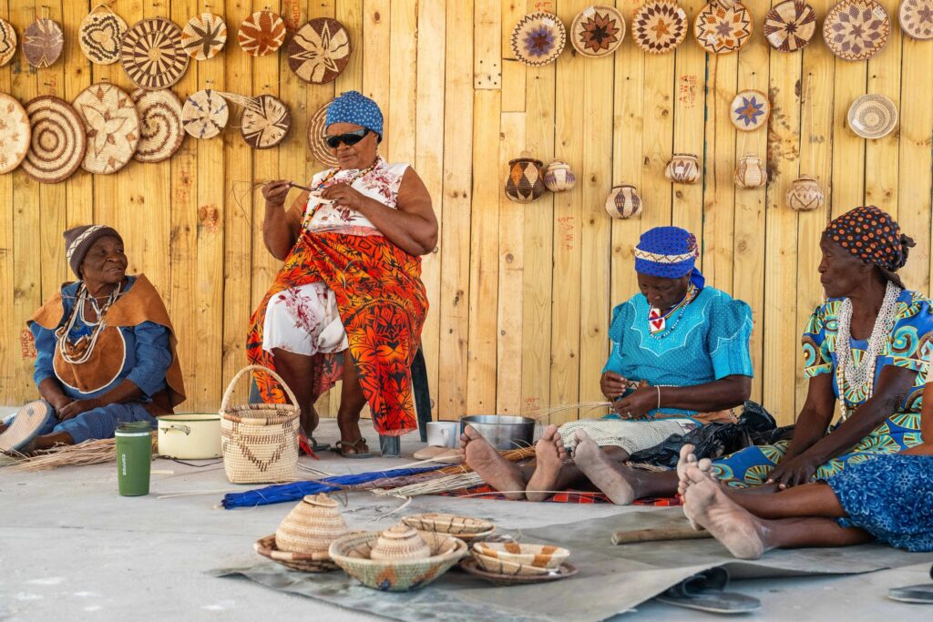 donne in abiti tradizionali creano prodotti di artigianato locale