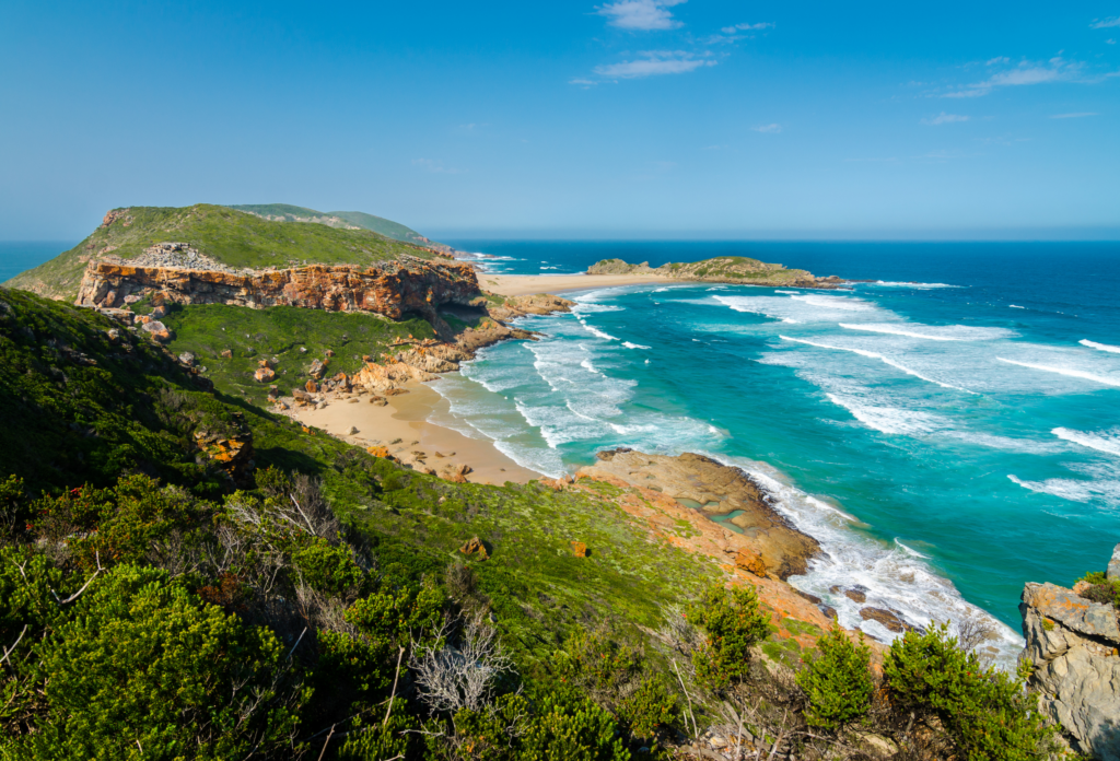 Scenic coastal landscape with rugged cliffs, sandy beaches and turquoise ocean in South Africa.